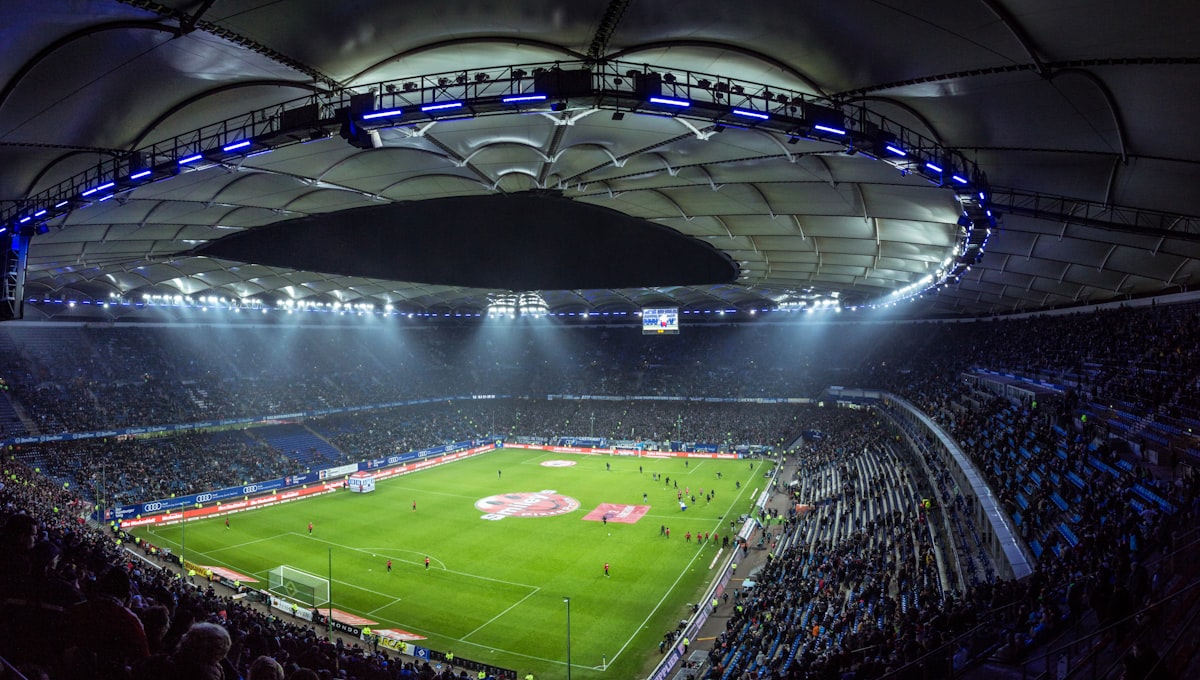 Wide view of a floodlit stadium bowl